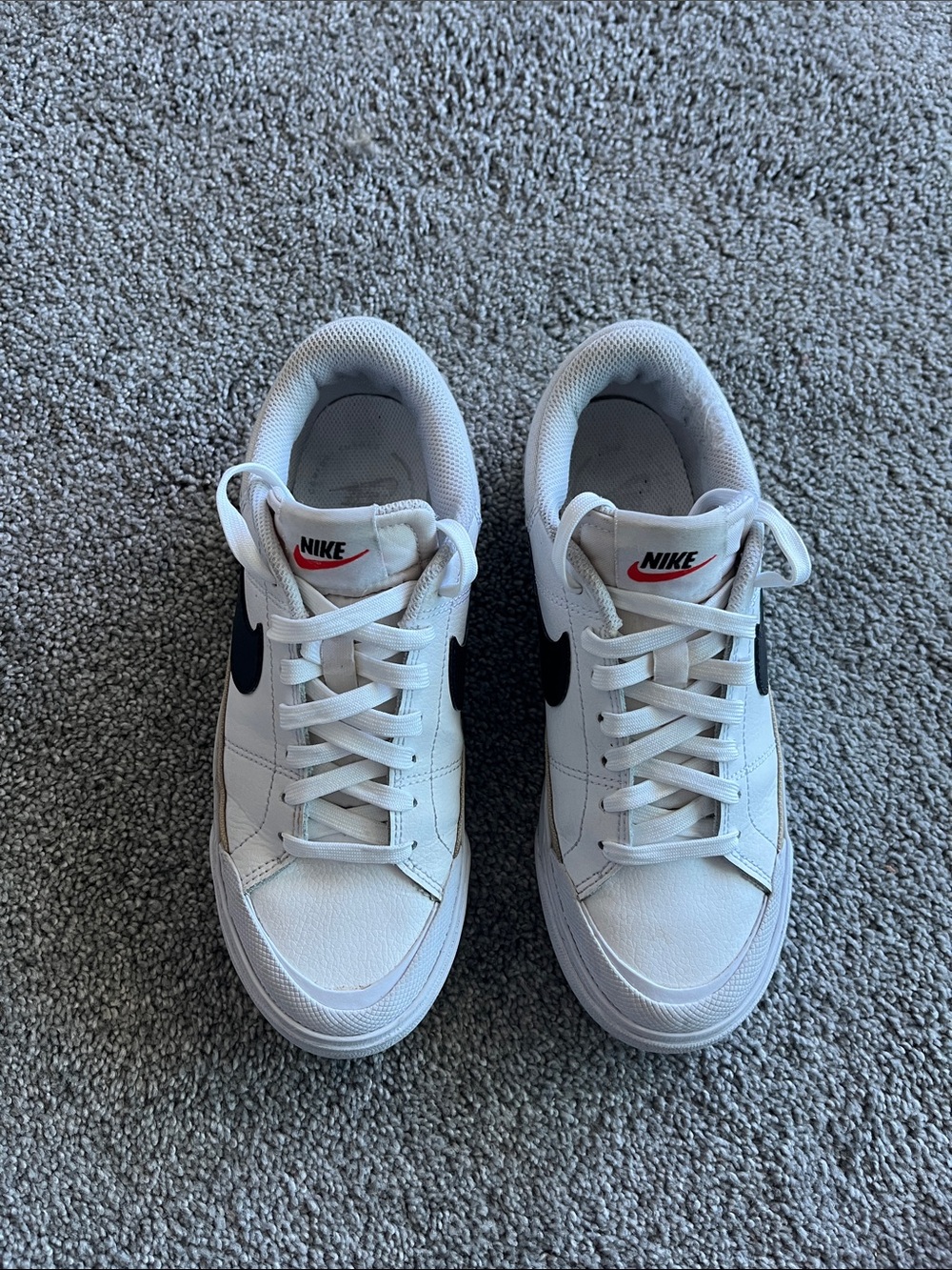 Nike White Low-Top Sneakers with Black Swoosh and Red Logo
